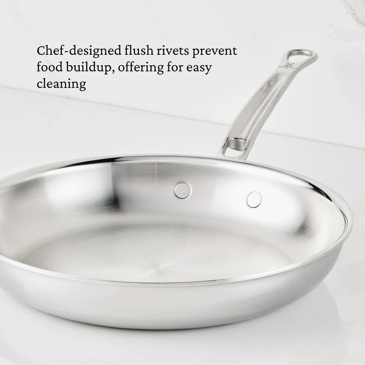 Stainless steel frying pan with text about flush rivets preventing food buildup.