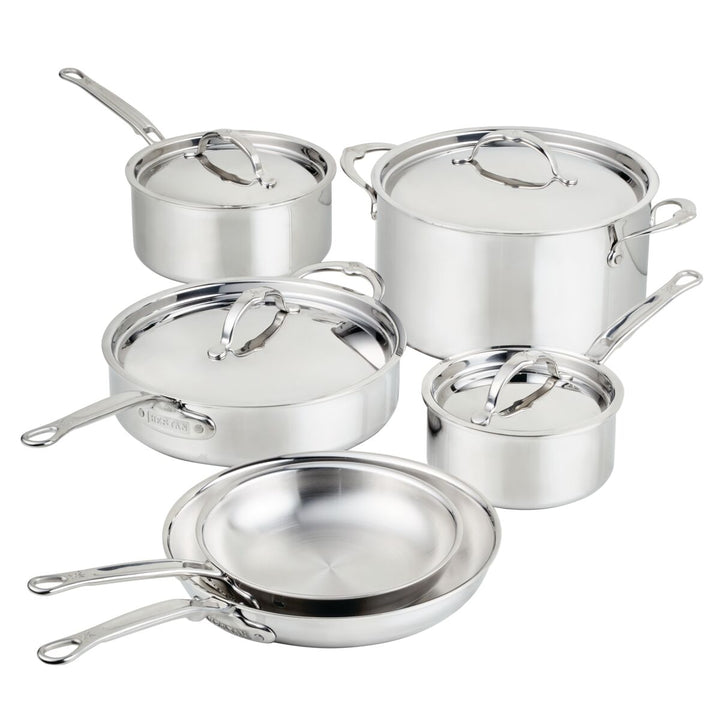 Set of stainless steel cookware with lids on a white background